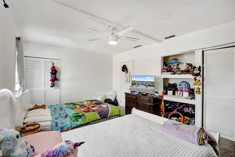 a bed room with a bed and a television