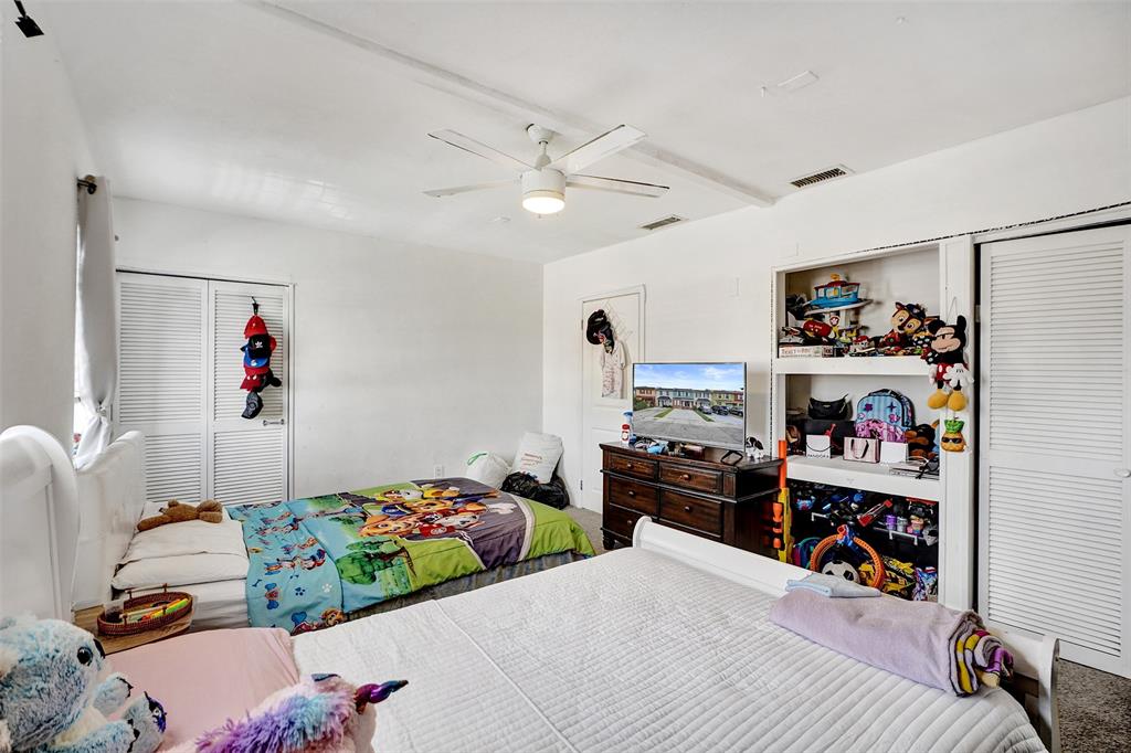 1732 West 72nd Street, Unit 1732 Hialeah, FL 33014 - Photo 27 of 58 a bedroom with bed and a chandelier