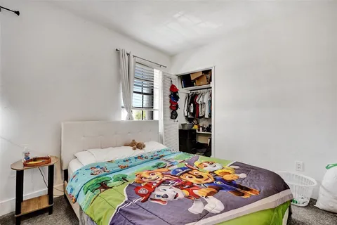 a bedroom with a bed and window