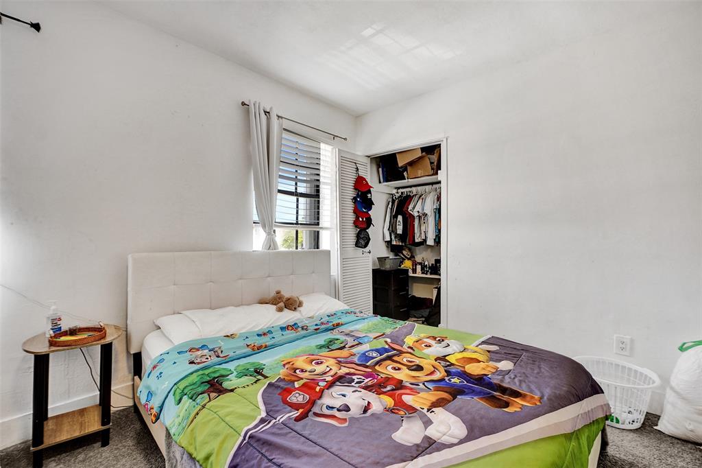 1732 West 72nd Street, Unit 1732 Hialeah, FL 33014 - Photo 28 of 58 a bedroom with a bed and wooden floor