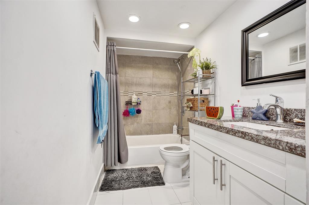 1732 West 72nd Street, Unit 1732 Hialeah, FL 33014 - Photo 30 of 58 a bathroom with a granite countertop sink mirror vanity and toilet