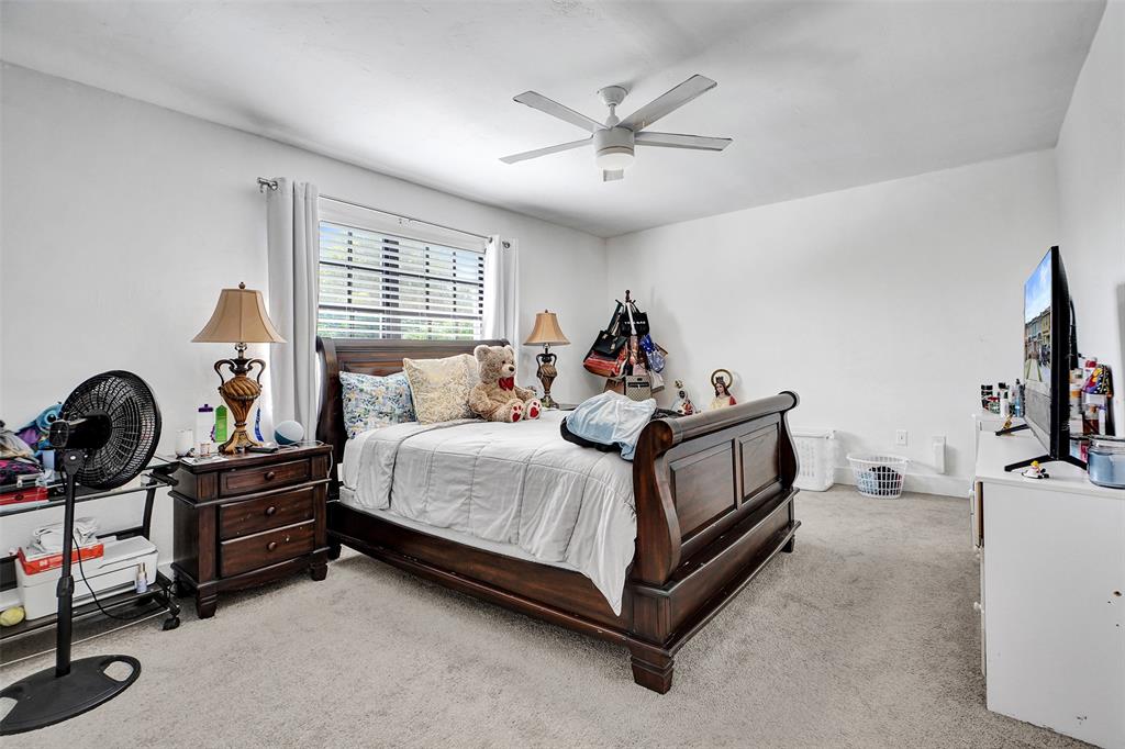 1732 West 72nd Street, Unit 1732 Hialeah, FL 33014 - Photo 31 of 58 a bed room with a bed and a television