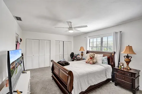 a view of a chair and table in backyard of the house
