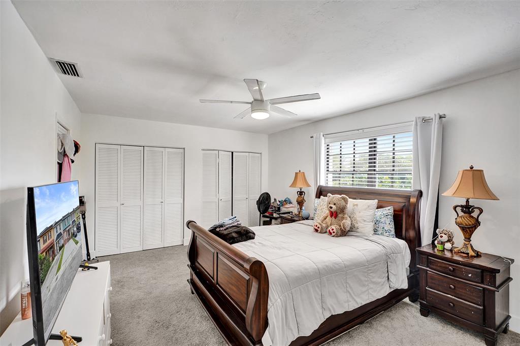 1732 West 72nd Street, Unit 1732 Hialeah, FL 33014 - Photo 33 of 58 a bedroom with a bed and a chandelier