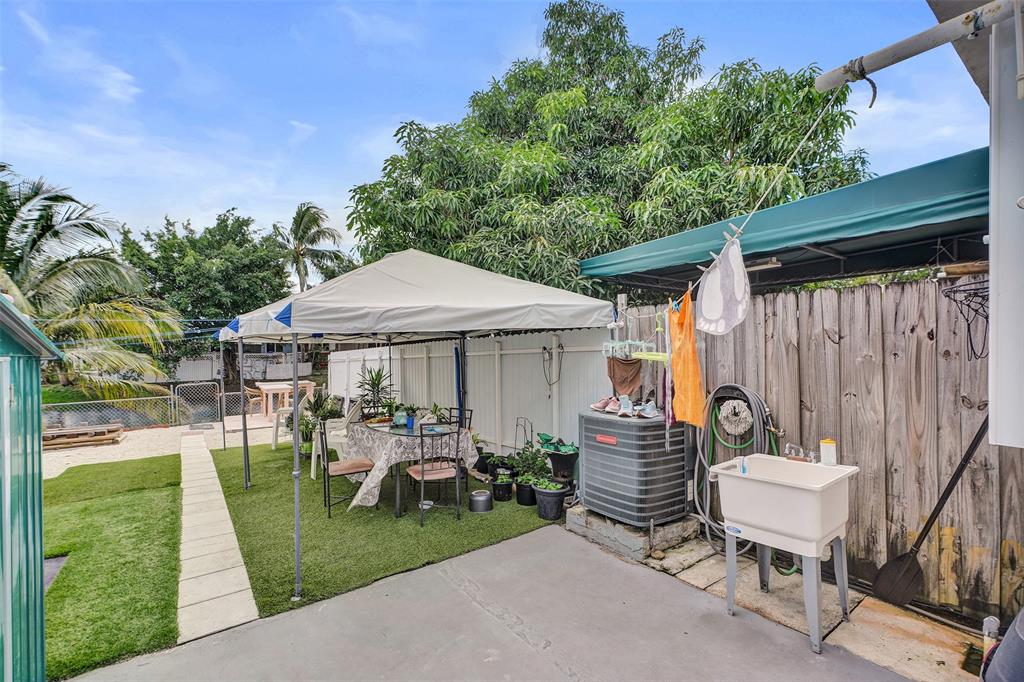 1732 West 72nd Street, Unit 1732 Hialeah, FL 33014 - Photo 37 of 58 a view of a chair and table in backyard of the house