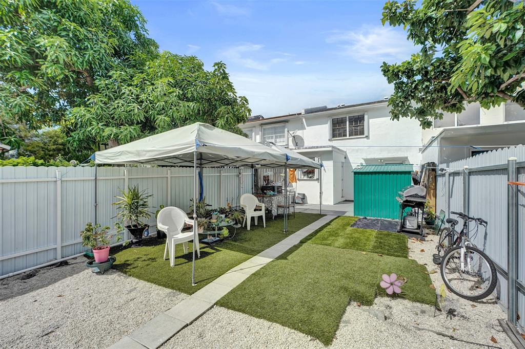 1732 West 72nd Street, Unit 1732 Hialeah, FL 33014 - Photo 44 of 58 a view of a patio with table and chairs under an umbrella