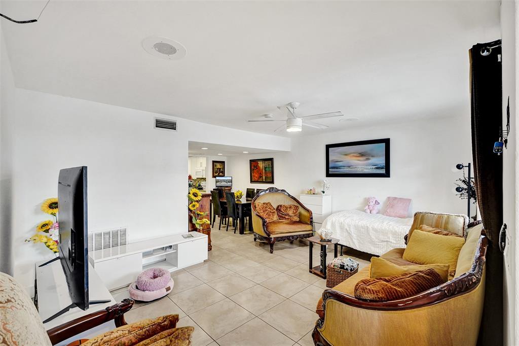 1732 West 72nd Street, Unit 1732 Hialeah, FL 33014 - Photo 6 of 58 a living room with furniture and a flat screen tv