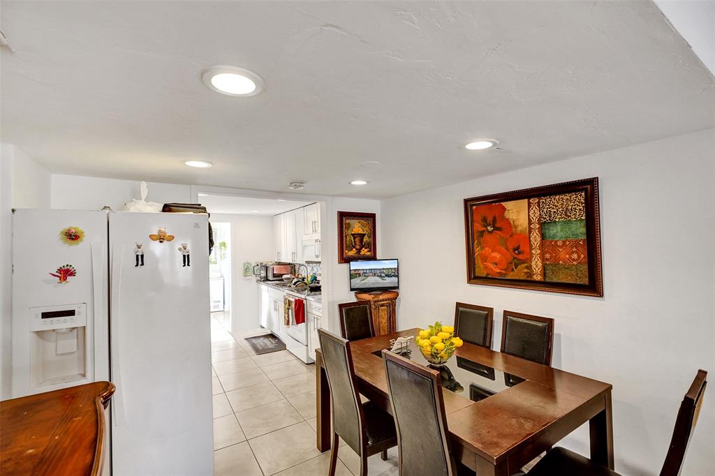 1732 West 72nd Street, Unit 1732 Hialeah, FL 33014 - Photo 8 of 58 a workspace with furniture and a flat screen tv