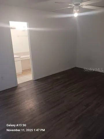 an empty room with wooden floor and entrance