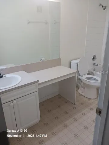 a bathroom with a sink toilet and vanity