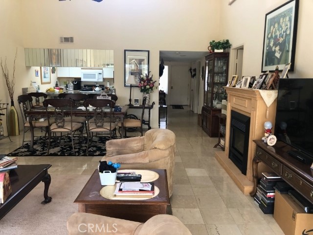 200 East Racquet Club Road, Unit 19 Palm Springs, CA 92262 - Photo 3 of 21 a living room with furniture and a fireplace