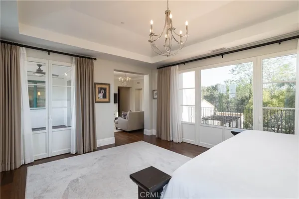 a bedroom with a large bed and a large window