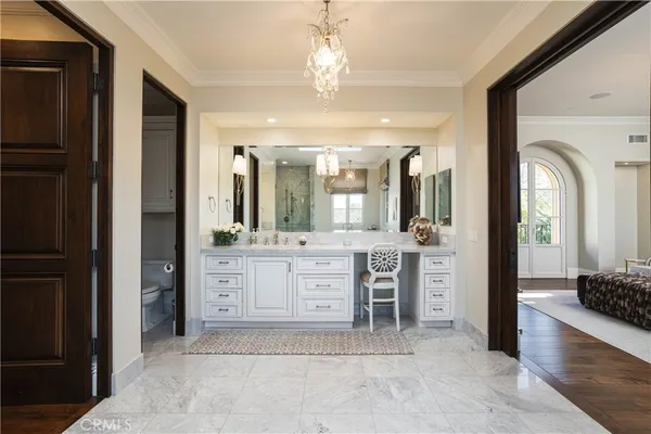 a spacious en suite bathroom with a granite countertop sink mirror and shower