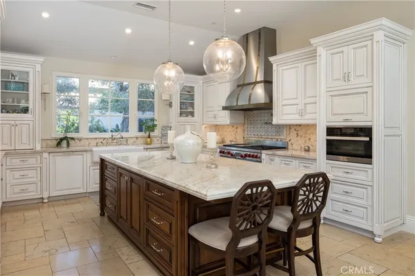a kitchen with a dining table and chairs