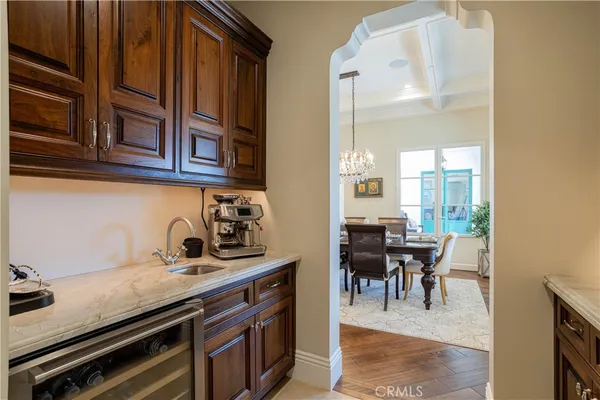 a view of dining room and kitchen with a table chairs wooden floor