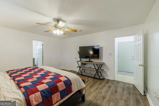 a bedroom with a bed and a flat screen tv