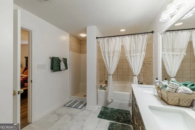 a bathroom with a double vanity sink mirror and toilet