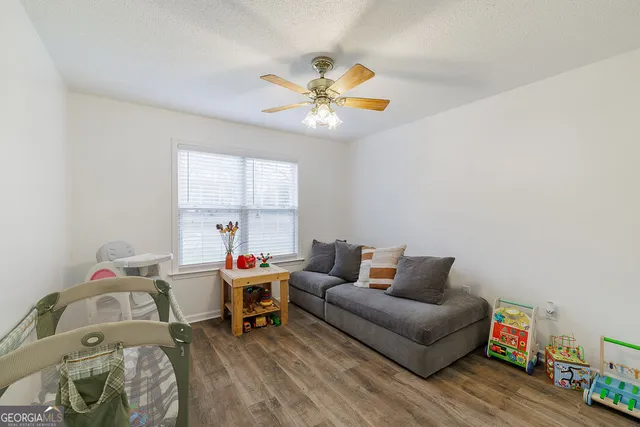 a living room with furniture and a chandelier