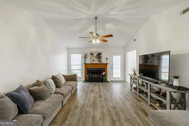 a living room with furniture and a flat screen tv