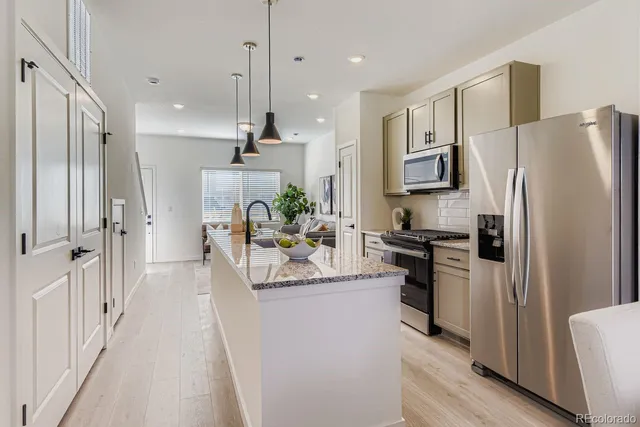 a kitchen with stainless steel appliances a refrigerator sink and stove