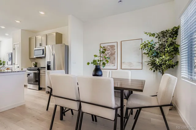 a view of a dining room with furniture and chandelier
