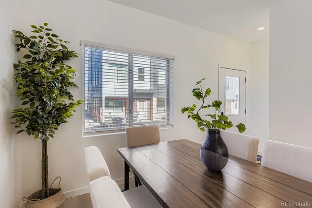 a view of a dining room with furniture window and wooden floor