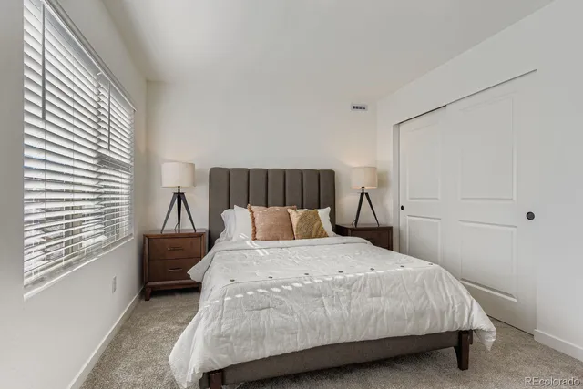 a bedroom with a bed and window
