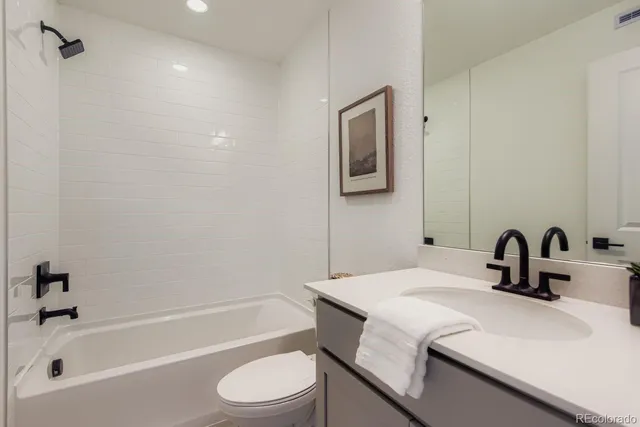 a bathroom with a sink a toilet and a bathtub