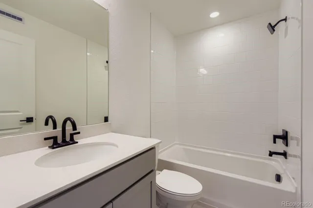 a bathroom with a sink a toilet and bathtub