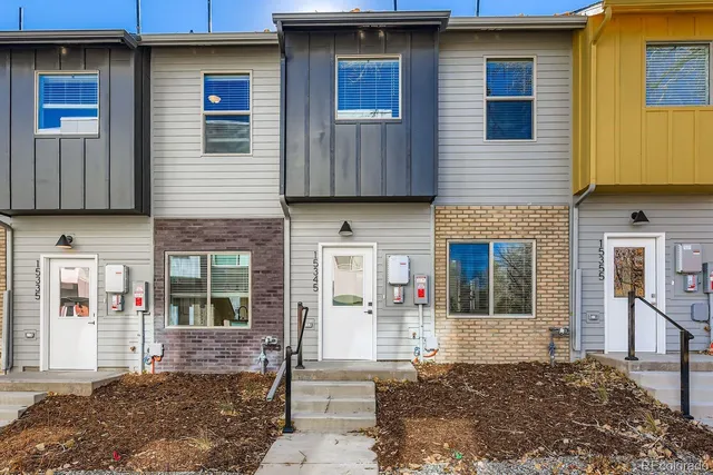 a front view of a house with large windows