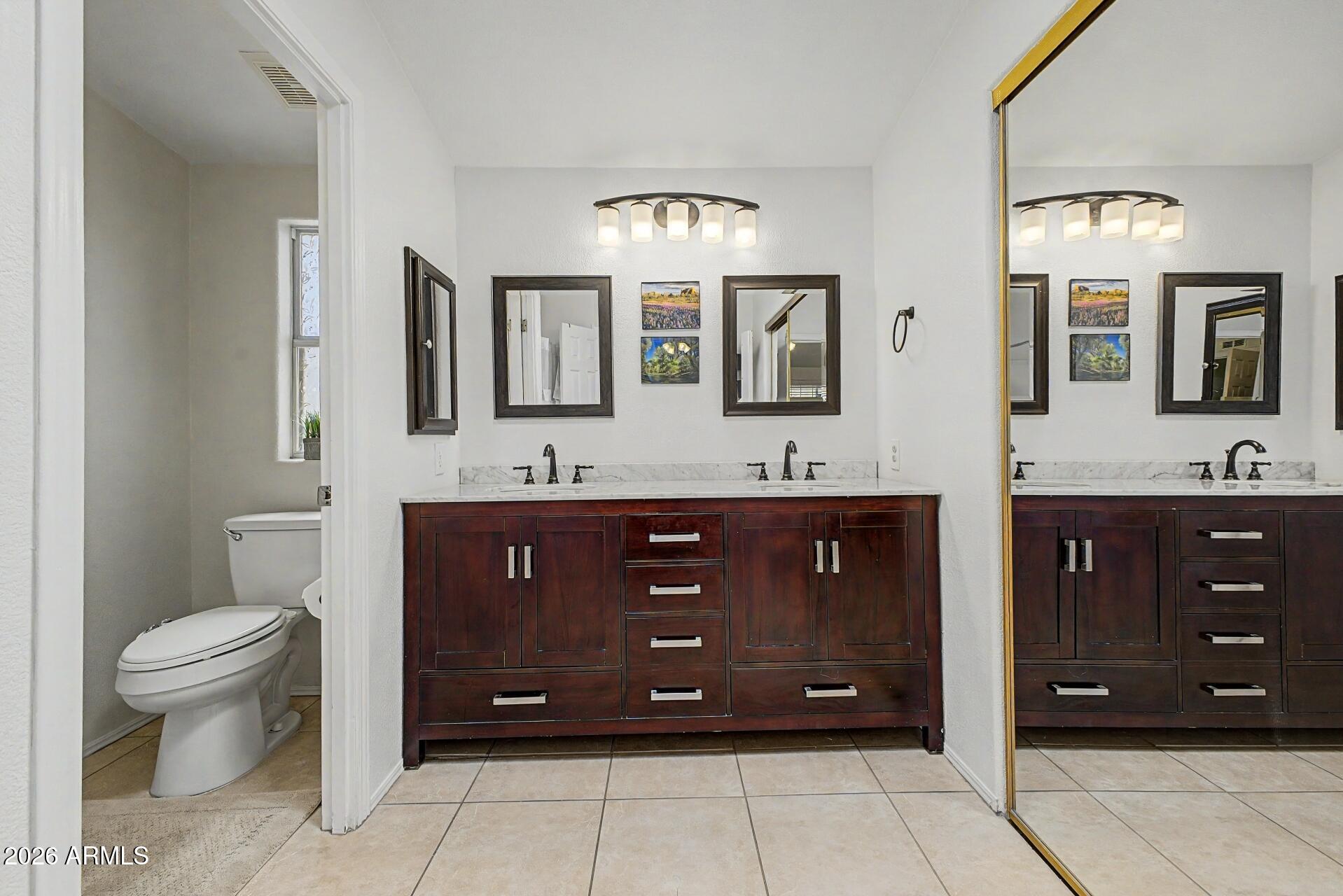 2550 South Ellsworth Road, Unit 46 Mesa, AZ 85209 - Photo 19 of 46 a bathroom with a granite countertop double vanity sink and a mirror