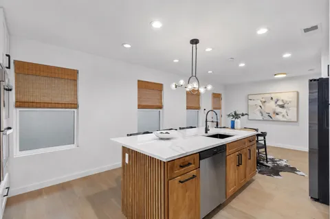 a view of a kitchen island a chandelier