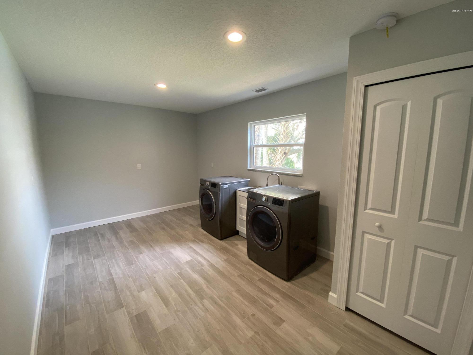367 Capri Road Cocoa Beach, FL 32931 - Photo 11 of 27 a view of a storage & utility room with two washing machine