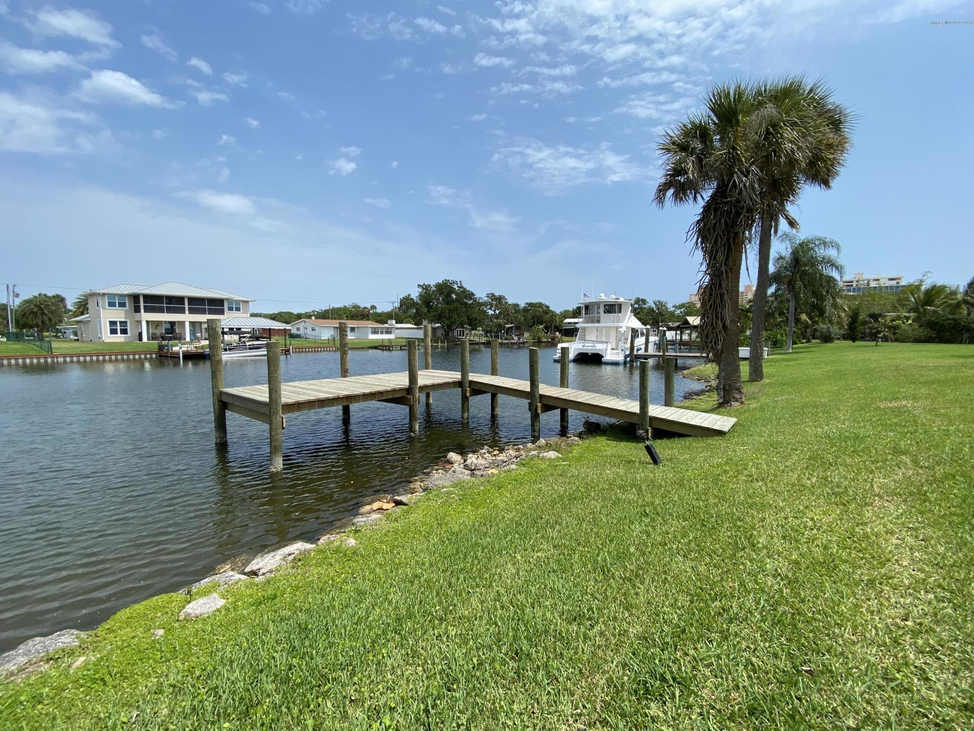 367 Capri Road Cocoa Beach, FL 32931 - Photo 12 of 27 a view of a lake with houses with outdoor space