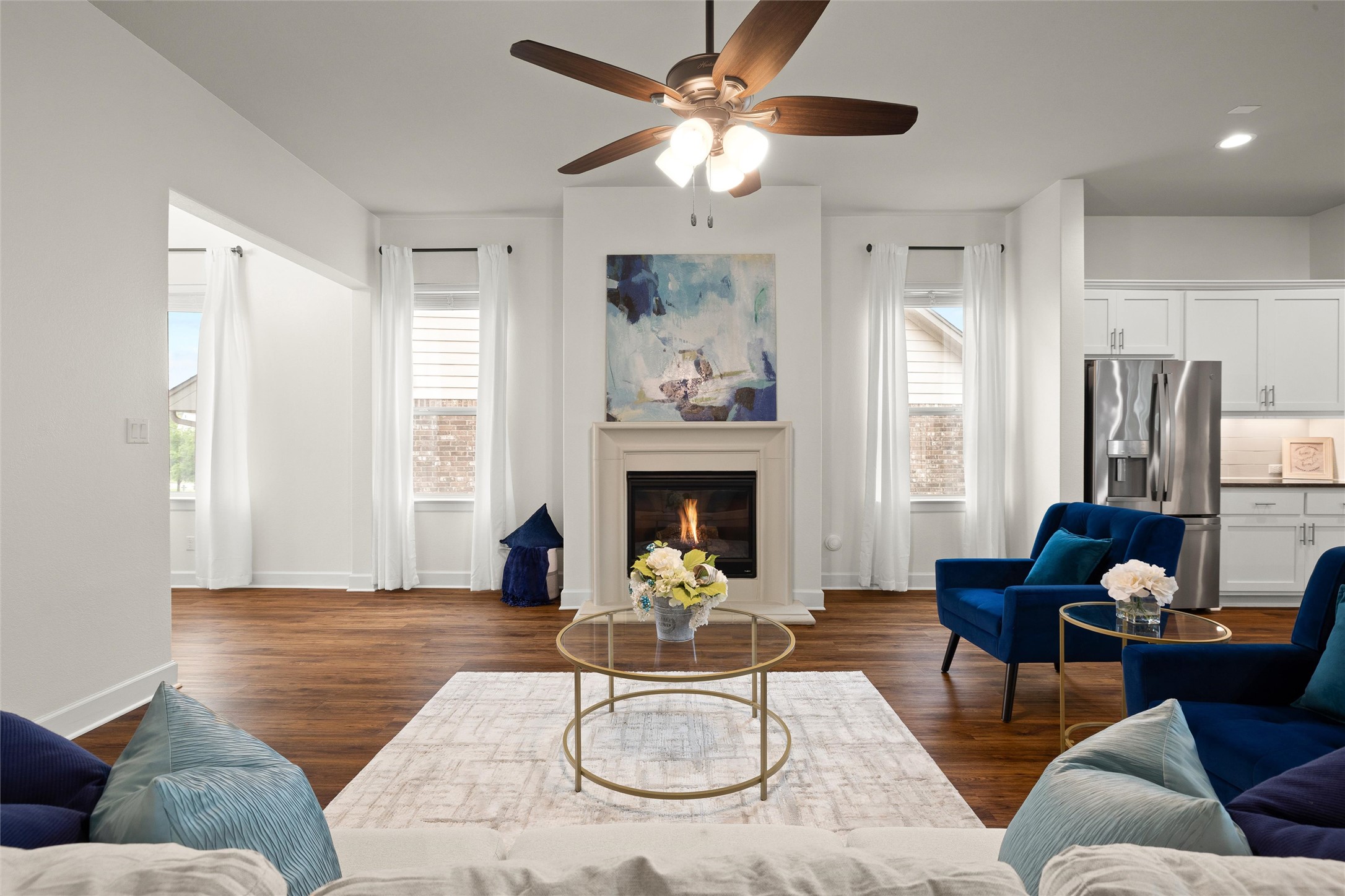 143 Bright Vly Way Austin, TX 78737 - Photo 12 of 34 a living room with furniture a fireplace and a chandelier