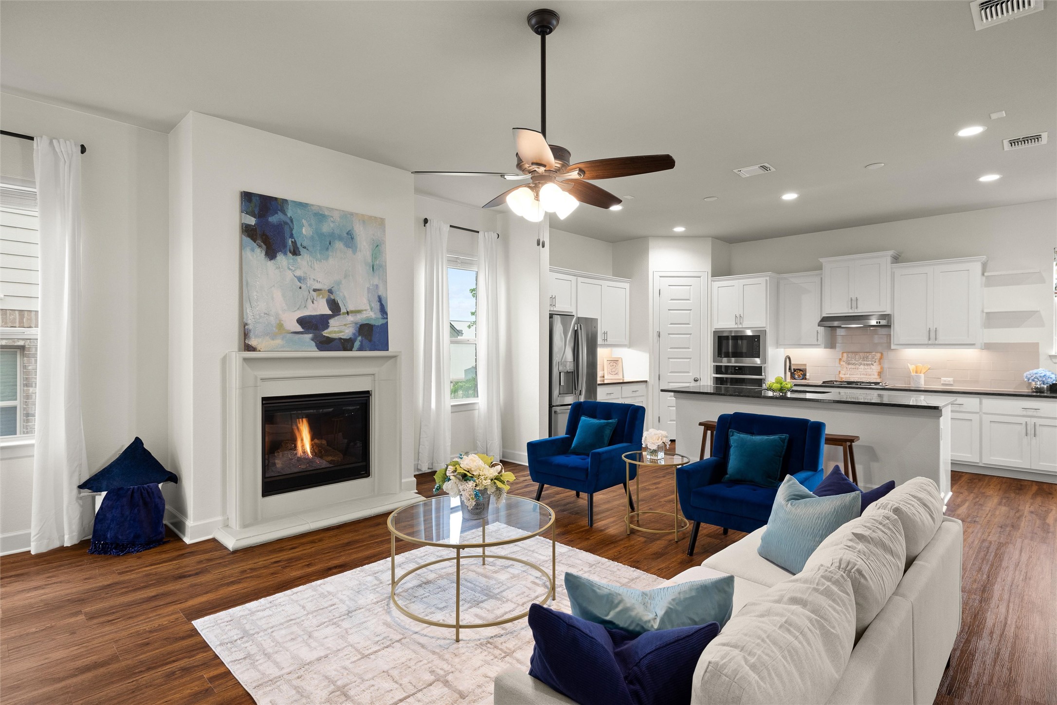 143 Bright Vly Way Austin, TX 78737 - Photo 13 of 34 a living room with furniture kitchen view and a fireplace