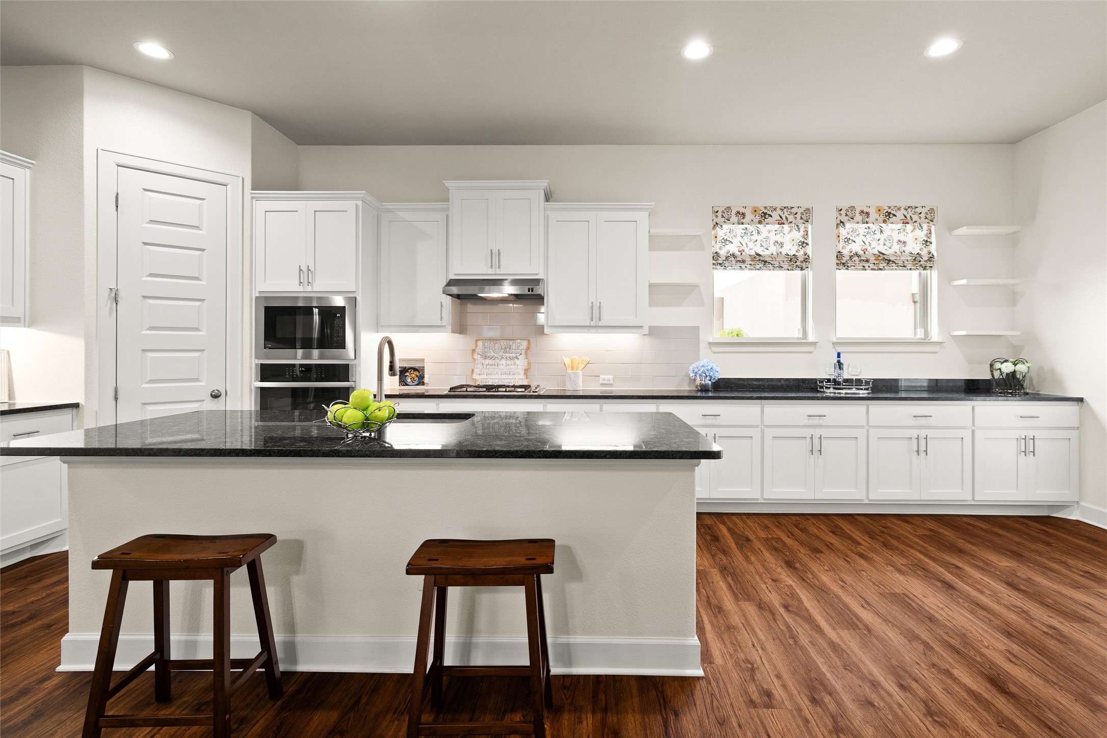 143 Bright Vly Way Austin, TX 78737 - Photo 14 of 34 a kitchen with granite countertop white cabinets and chair