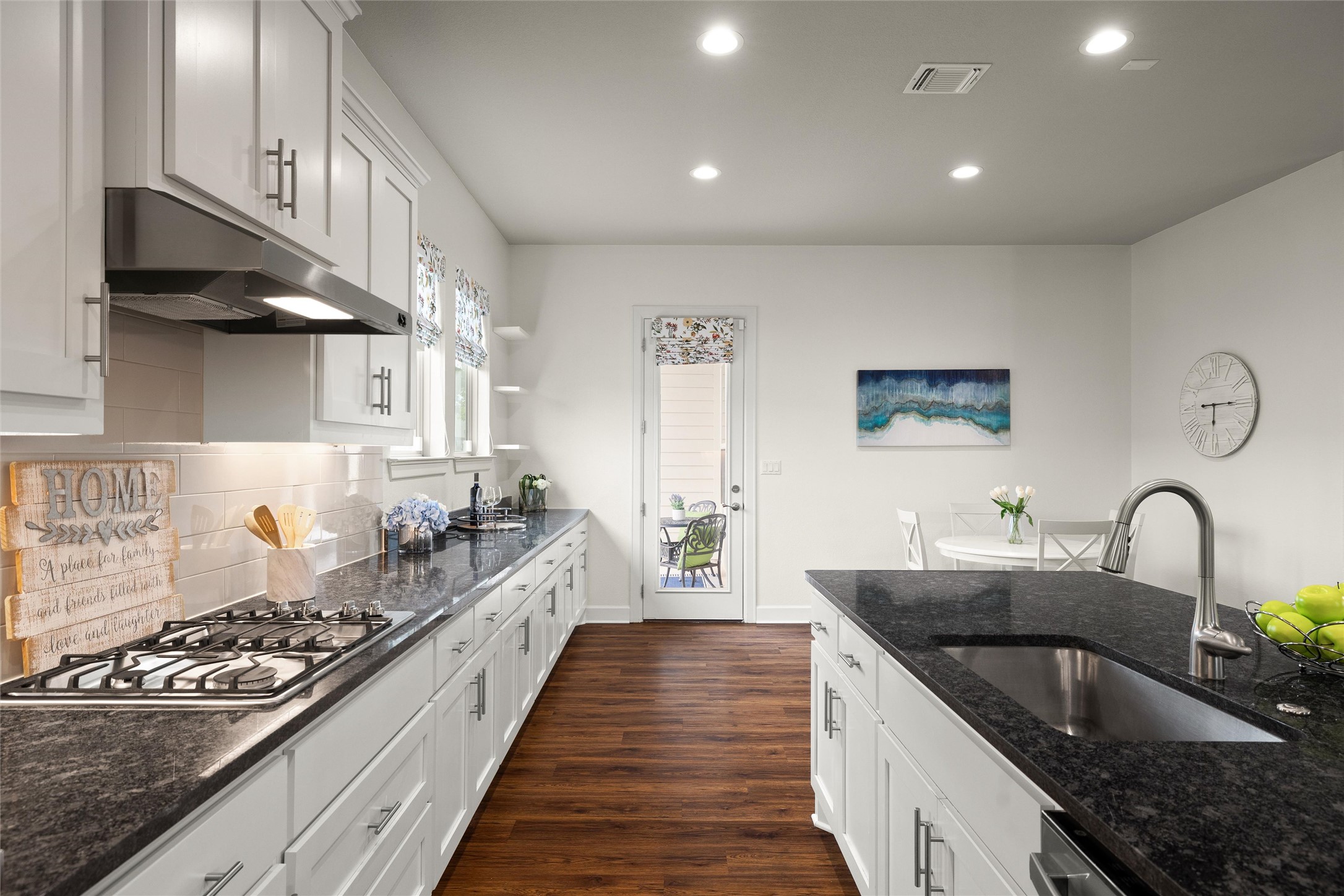 143 Bright Vly Way Austin, TX 78737 - Photo 17 of 34 a kitchen with granite countertop a sink stove and cabinets