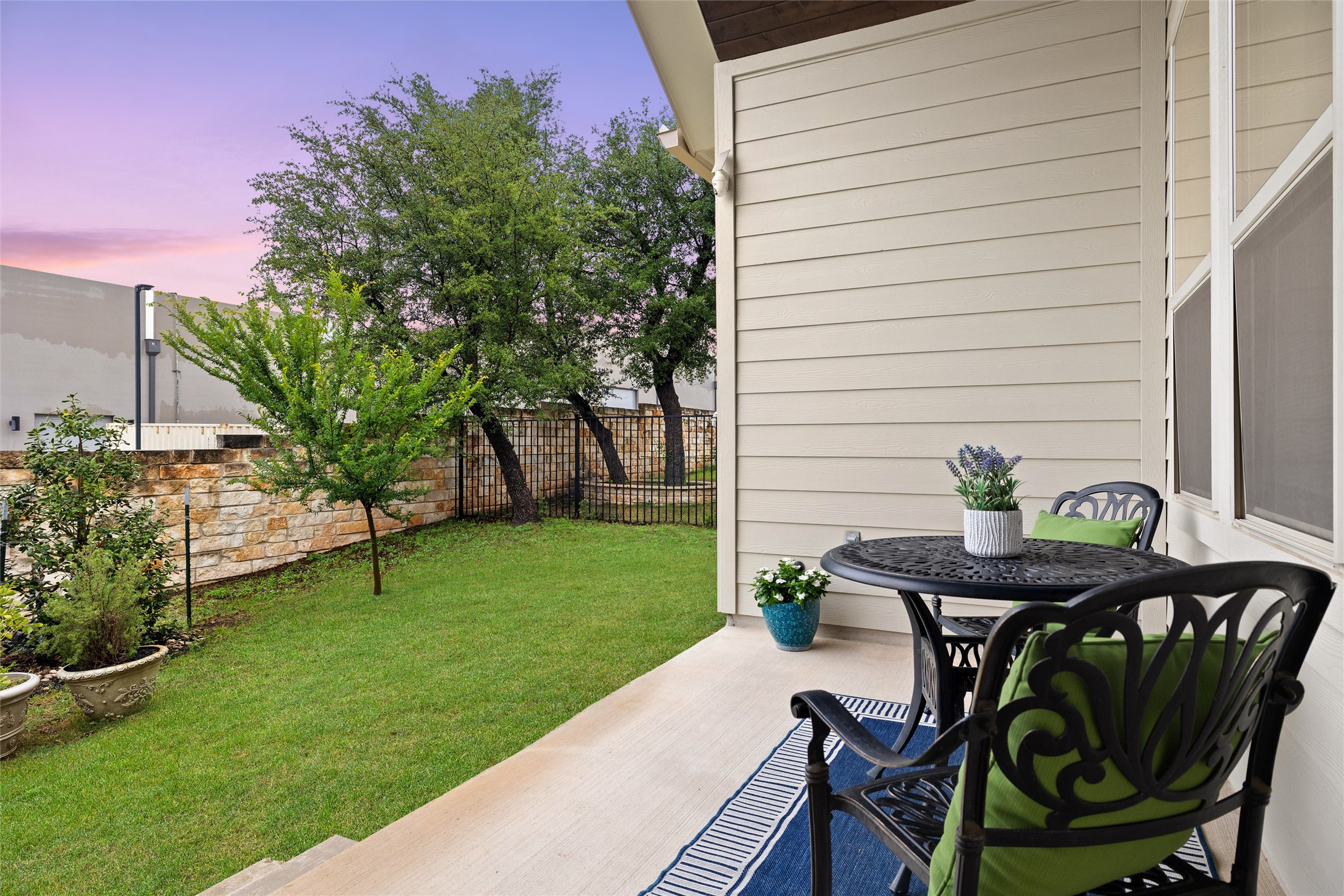 143 Bright Vly Way Austin, TX 78737 - Photo 32 of 34 a backyard of a house with table and chairs