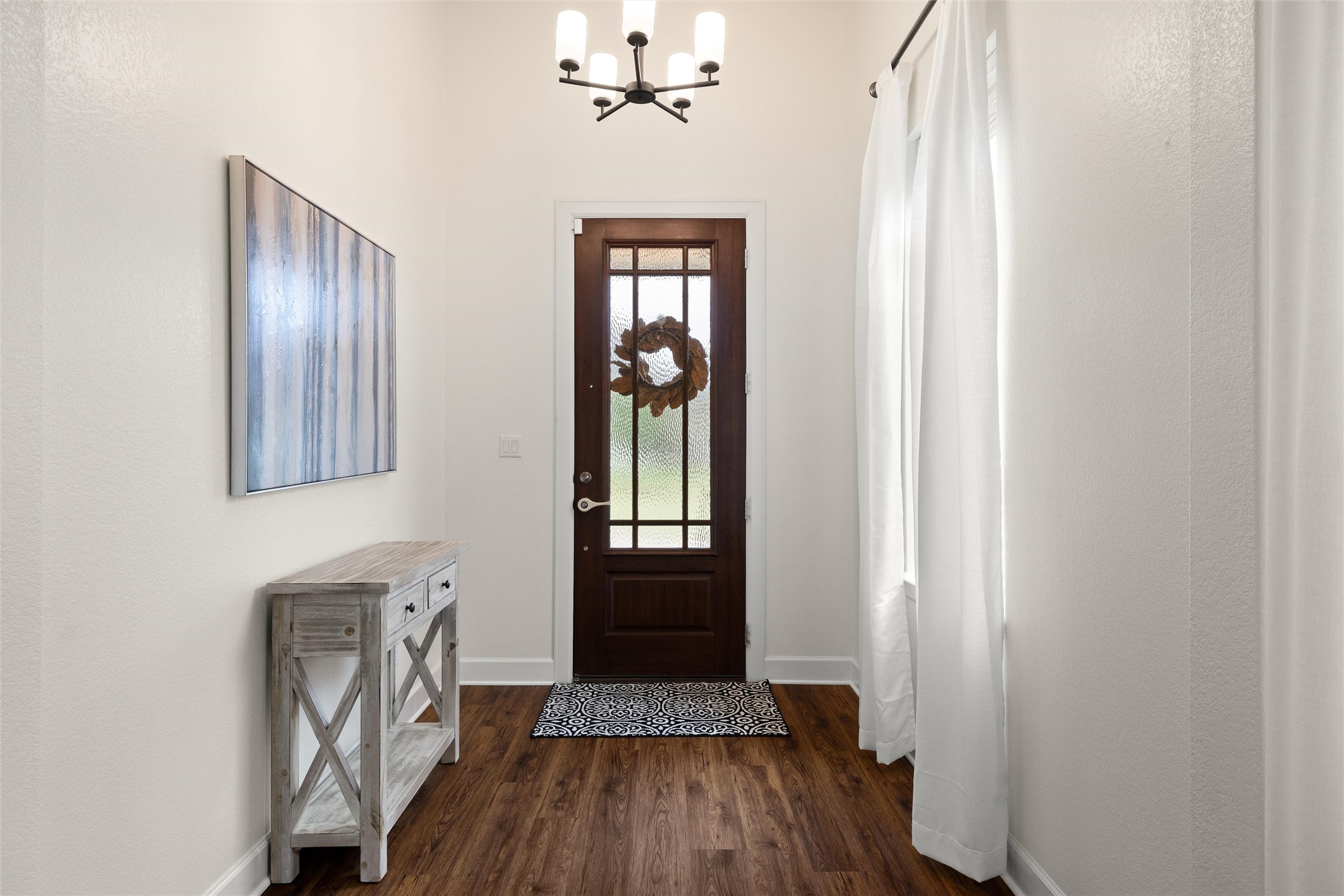 143 Bright Vly Way Austin, TX 78737 - Photo 7 of 34 a view of a hallway with wooden floor and staircase