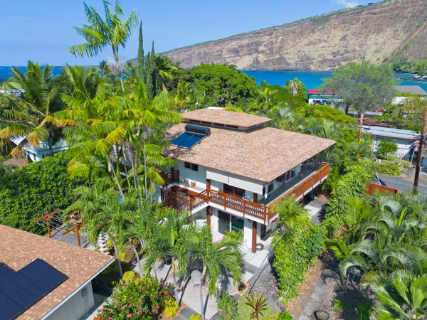 an aerial view of a house with a yard