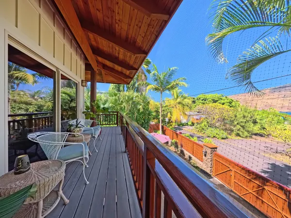 a view of a backyard with plants and outdoor seating