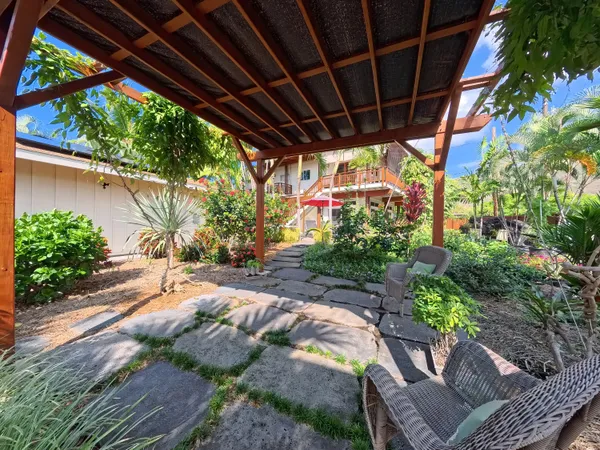 a view of a backyard with plants and a patio
