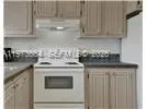 a kitchen with stainless steel appliances granite countertop a sink stove and microwave