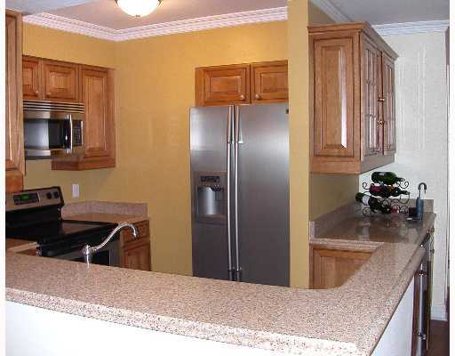 Undisclosed Address Cos Cob, CT 06807 - Photo 2 of 4 a kitchen with stainless steel appliances granite countertop a refrigerator a stove and a sink with wooden floors