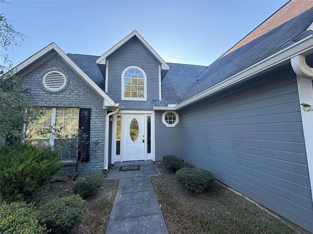 a front view of a house with garden