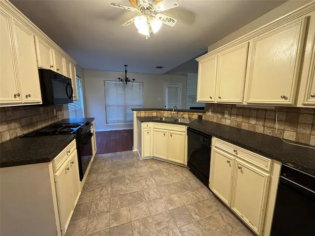 a kitchen with a stove a sink and a microwave