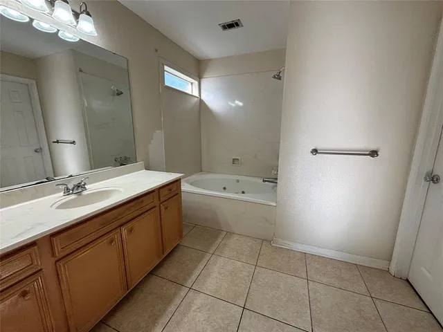 a bathroom with a double vanity sink a toilet and mirror