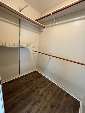 a view of a room with wooden floor