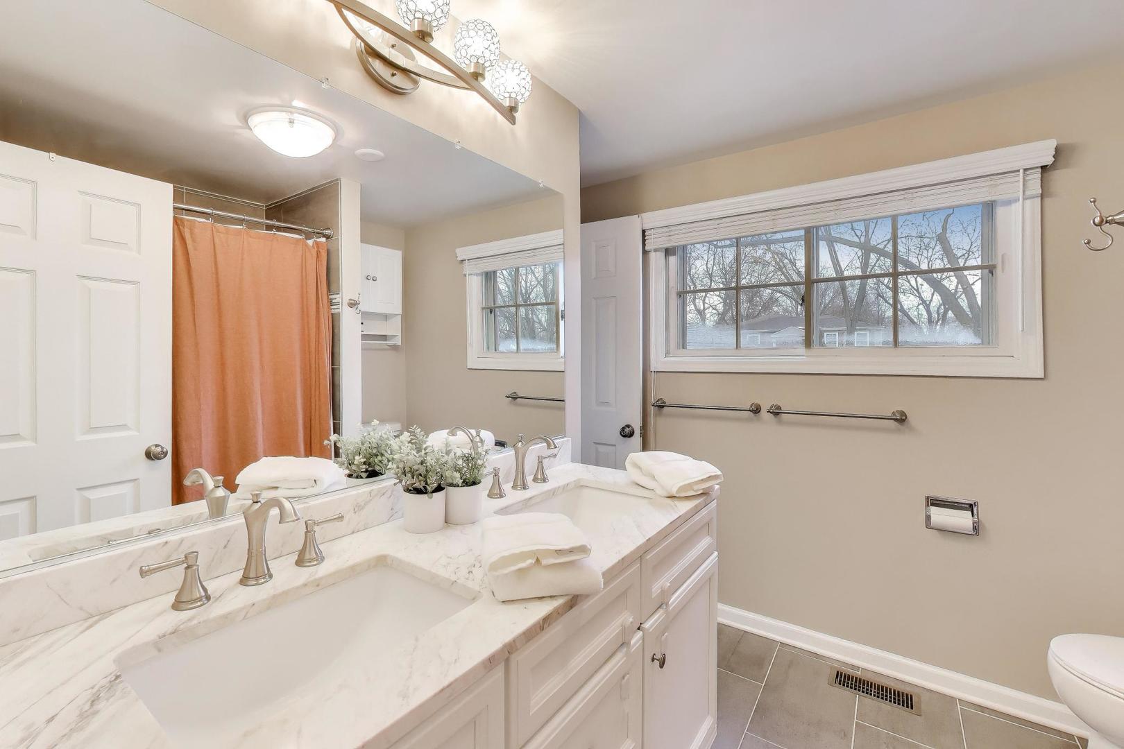 421 Berry Drive Naperville, IL 60540 - Photo 14 of 26 a bathroom with a granite countertop sink mirror and a shower